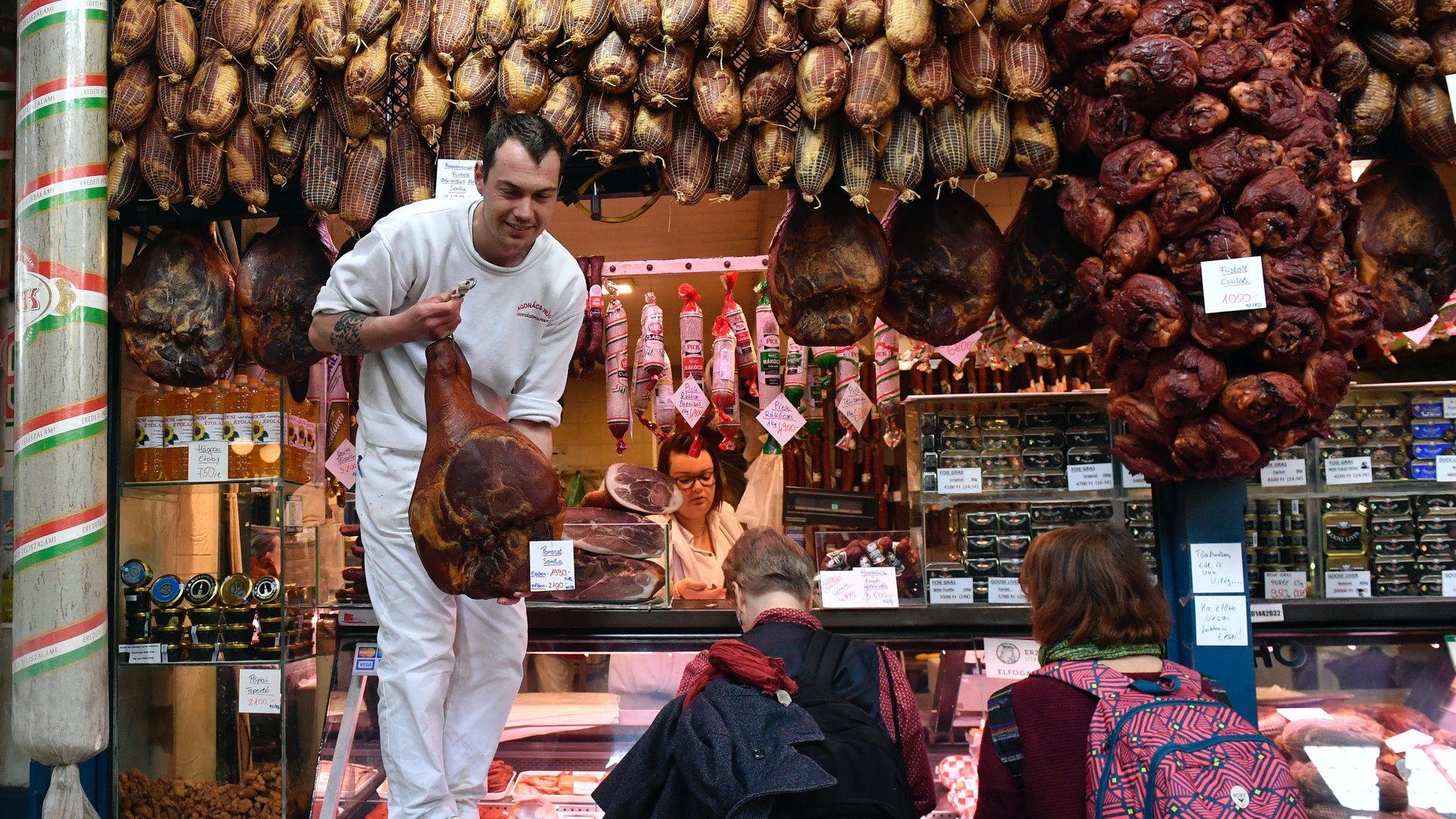 Húsvéti füstölt sonkát vásárolnak egy hús- és hentesárut árusító standnál a budapesti Fővám téri Központi Vásárcsarnokban 2019. április 10-én (Fotó: MTI/Máthé Zoltán)