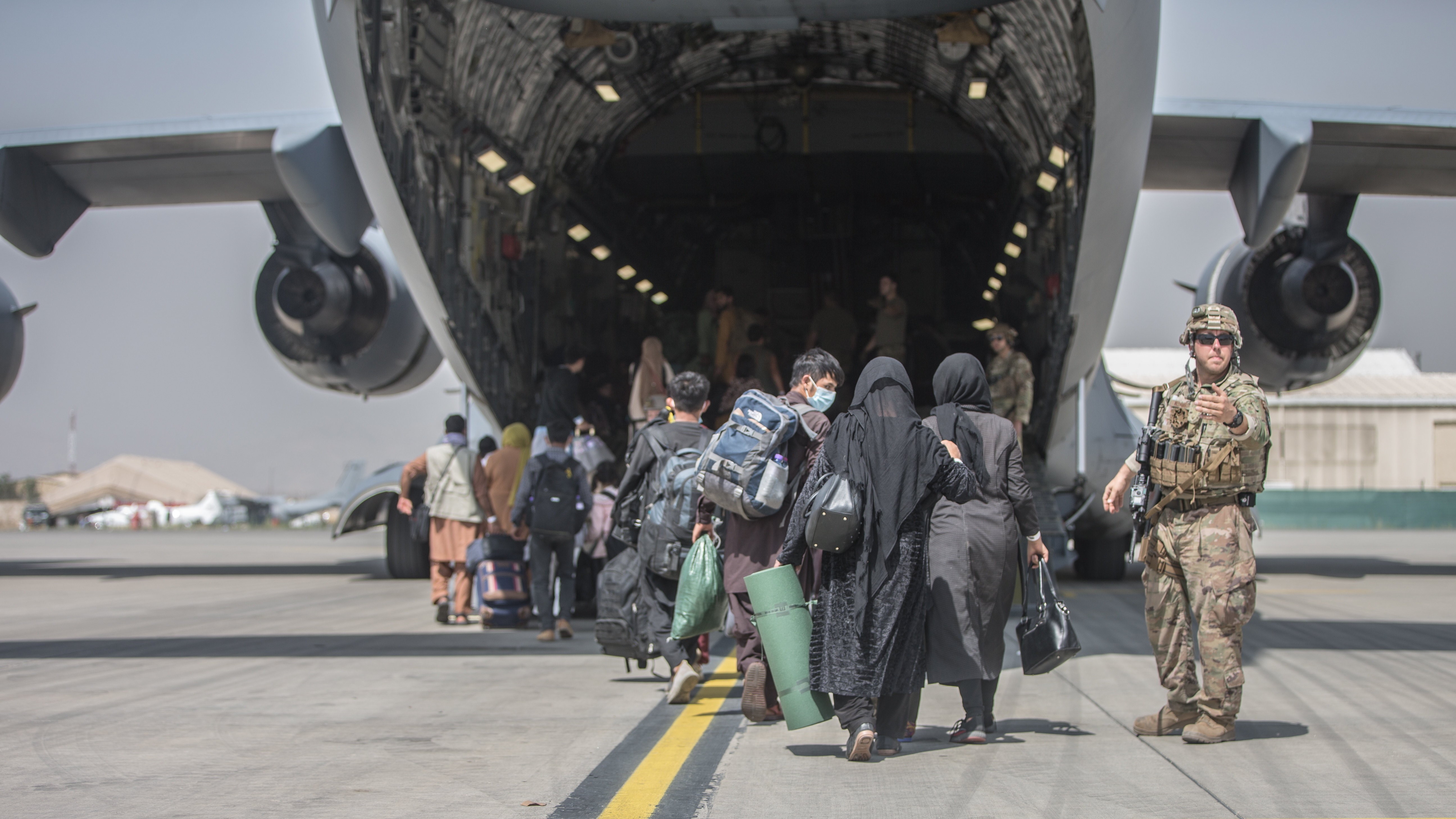 Kabul, 2021. augusztus 24.Az amerikai központi parancsnokság által közreadott képen afgánok beszállnak egy C-17 Globemaster III amerikai katonai teherszállító repülőgépbe a kabuli Hamid Karzai Nemzetközi Repülőtéren 2021. augusztus 23-án. Az Egyesült Államok és szövetségesei a légikikötőn keresztül menekítik ki a külföldi állampolgárokat és a velük együttműködő afgánokat, miután az iszlamista tálibok elfoglalták Afganisztán csaknem egészét.MTI/EPA/Amerikai központi parancsnokság/Samuel Ruiz