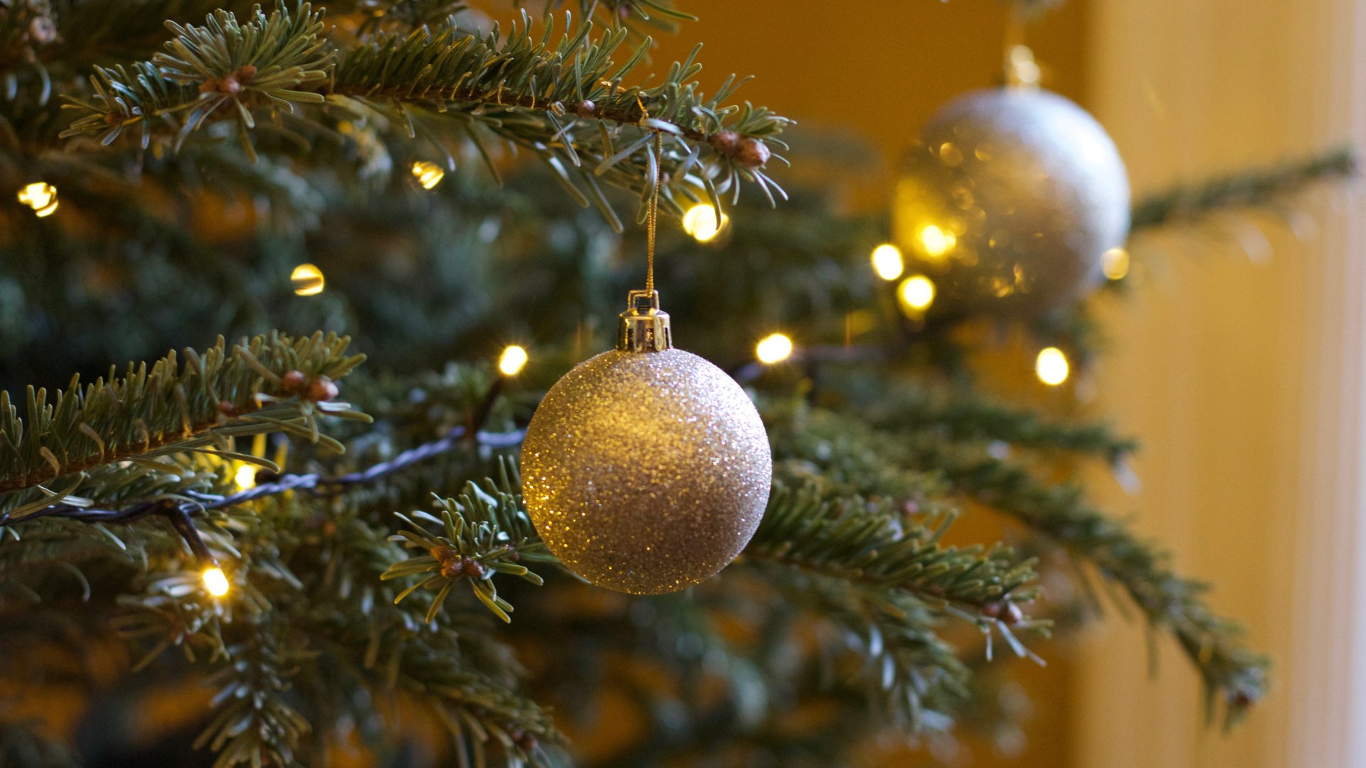 Aranszínű gömbök a feldíszített karácsonyfán