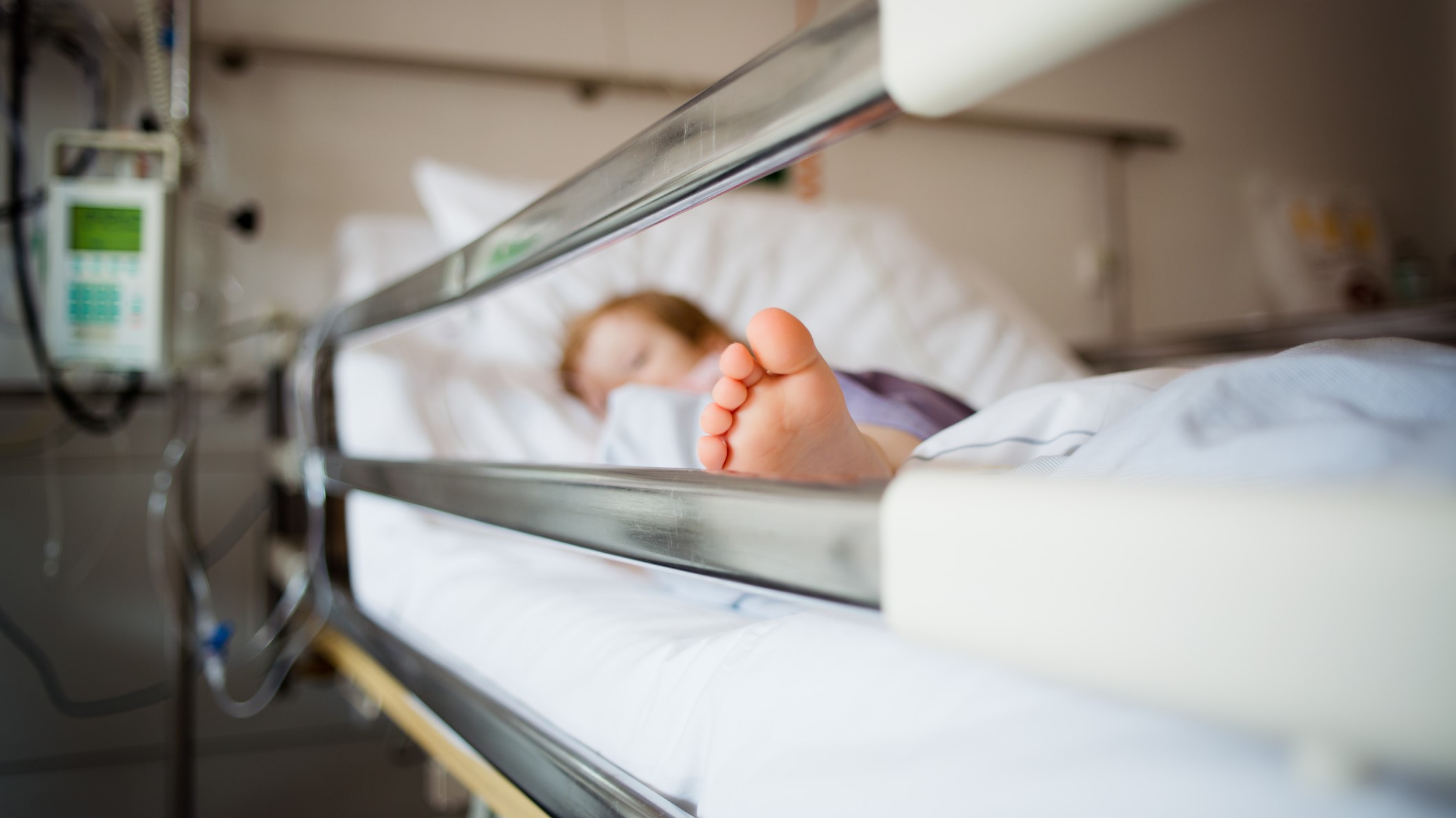 Gyermek fekszik egy kórházi ágyban