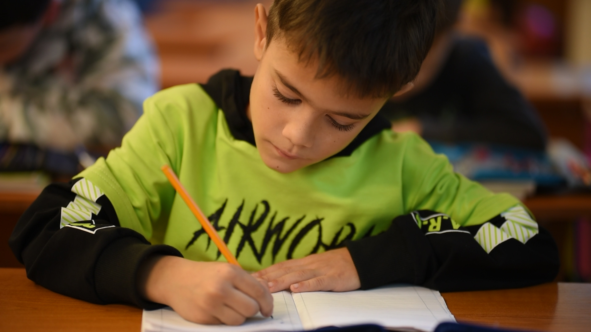 Kisgyerek írni tanul az iskolában