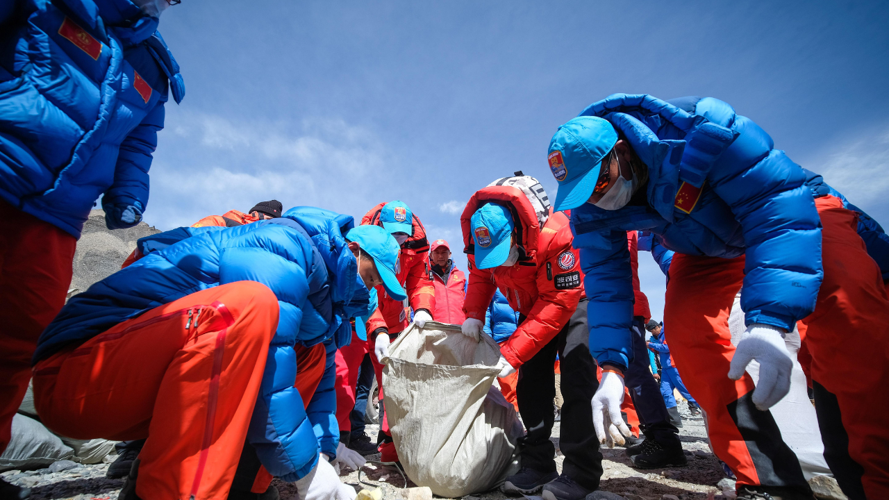 Climbers collect garbage prior to a ceremony to mark the 60th anniversary for human beings to reach the summit of Mount Qomolangma, or Mount Everest, via the north ridge at the Mount Qomolangma base camp on May 11, 2020 in Tibet Autonomous Region, China