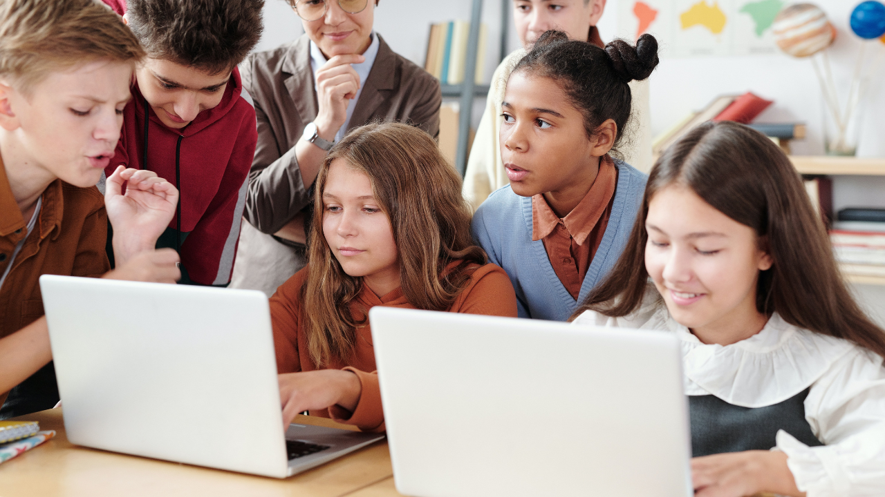 A gyerekek a laptop előtt tanulnak az iskolában