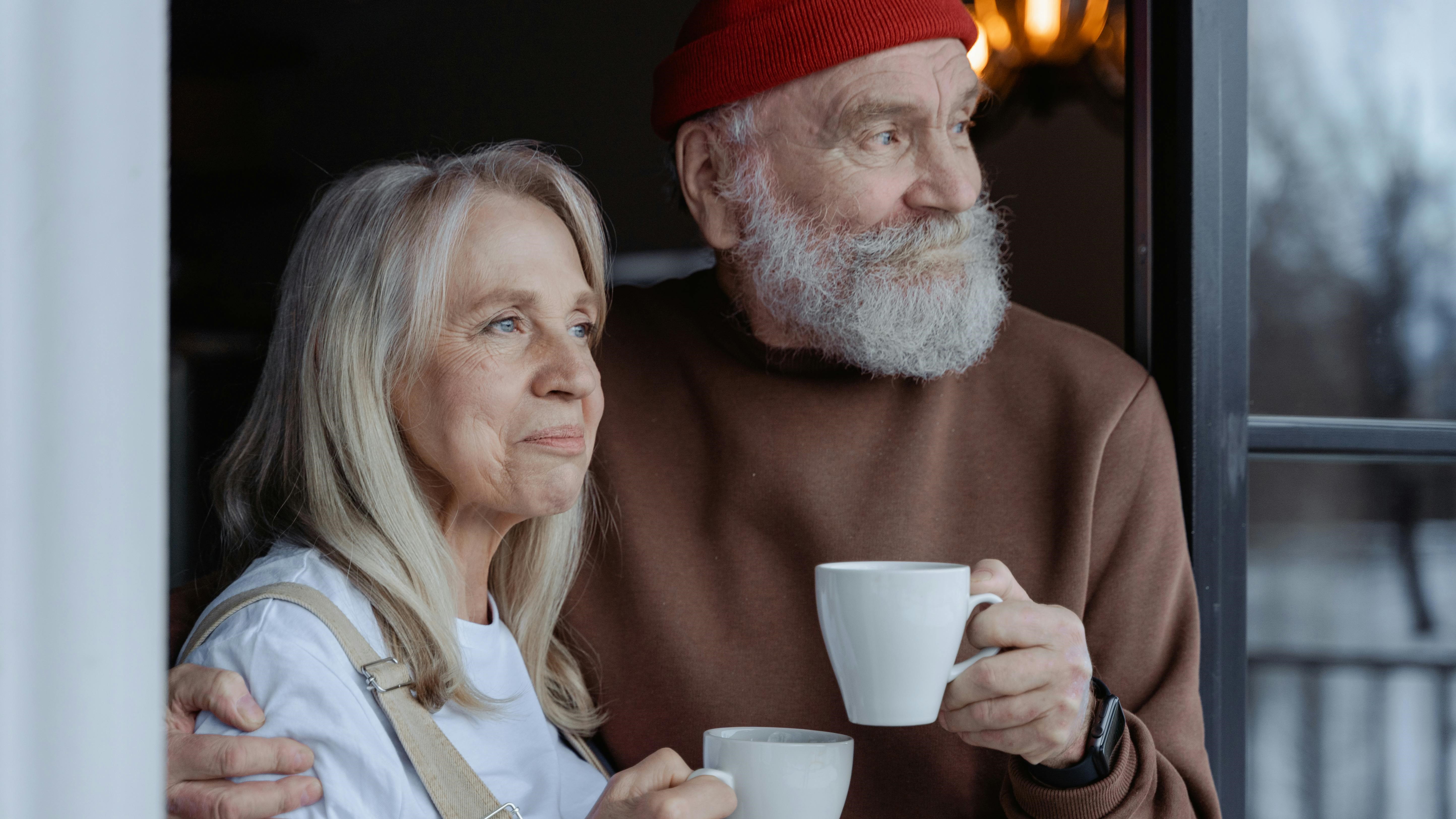 Idős pár a teraszajtóban kávézik