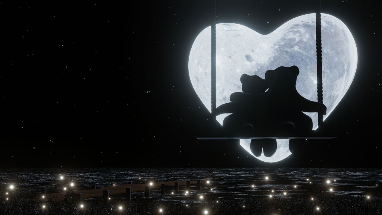 Macipár hintán a szív alakú Hold előtt